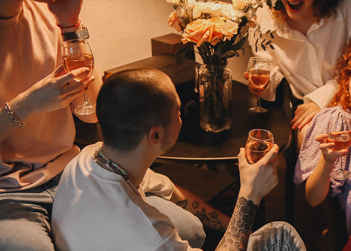 Group of friends holding drinks at party moment to leave immediately