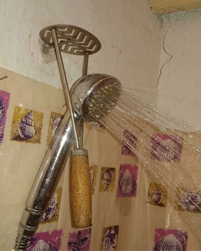 A makeshift showerhead constructed from a potato masher, illustrating unique Slavic science.