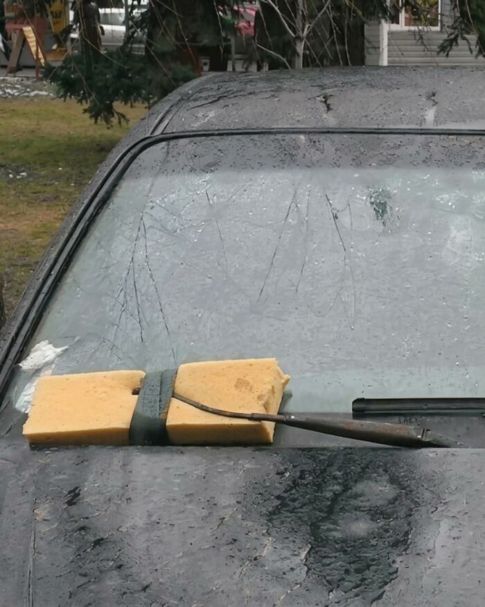 Two sponges taped to a car's windshield wiper, a practical example of Slavic Science.