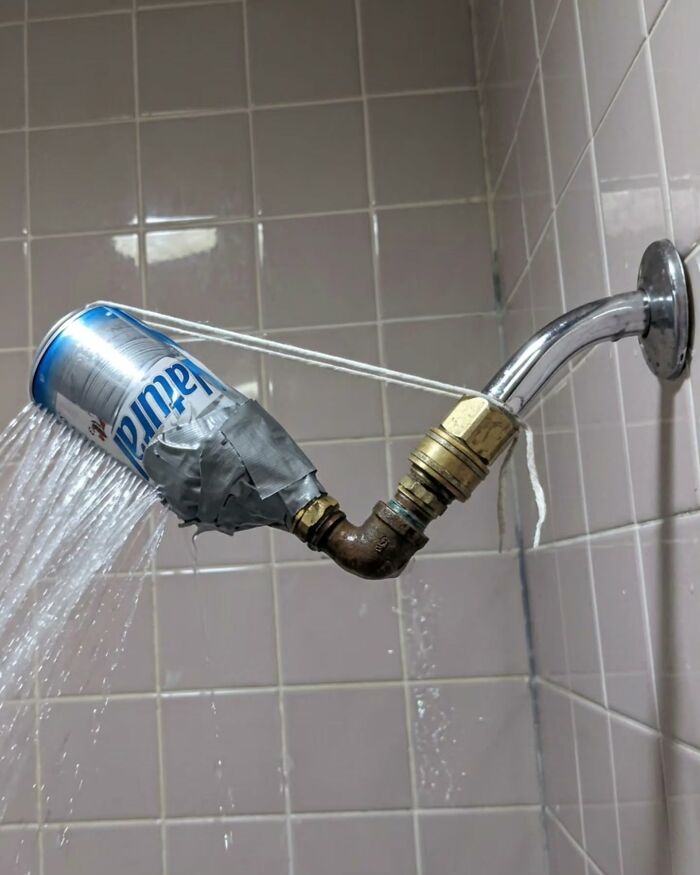 A showerhead rigged with a soda can and duct tape, demonstrating clever Slavic Science.