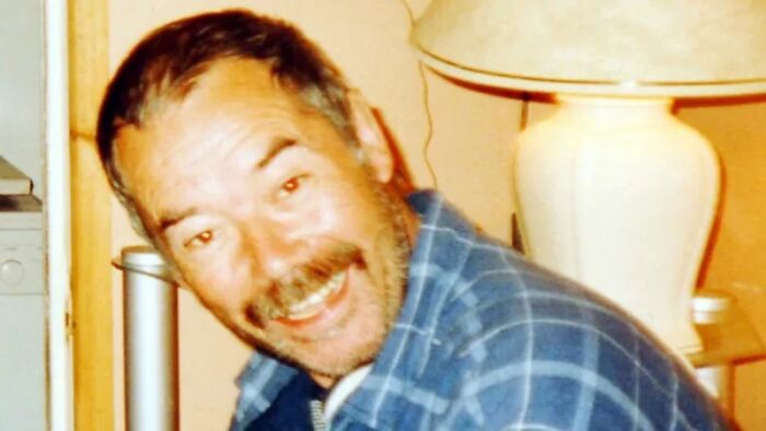 Close-up of a smiling man in a blue plaid shirt, his face showing the look of a solved mystery.