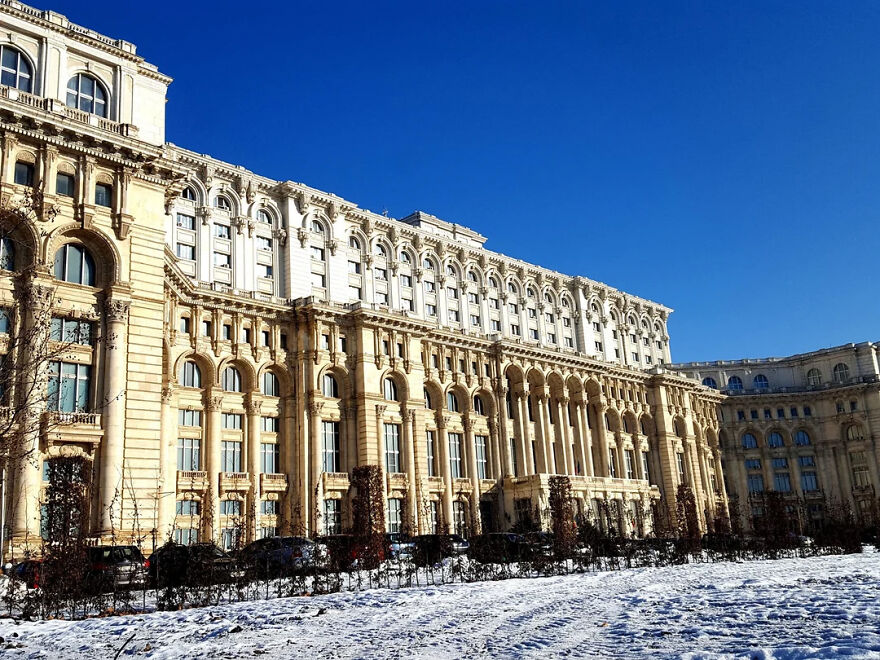 The Palace Of Parliament with ornate columns under clear blue sky
