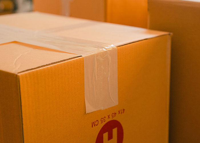 A brown cardboard box sealed with clear packing tape, representing unserious solutions.