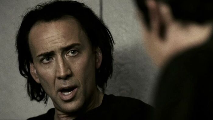 Nicolas Cage with an intense expression, perhaps from a plane interaction.