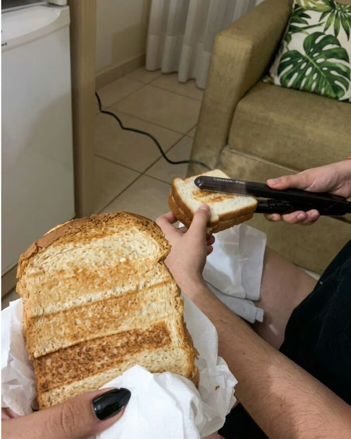 Someone using a hair straightener to toast bread, an example of peculiar Slavic Science methods.