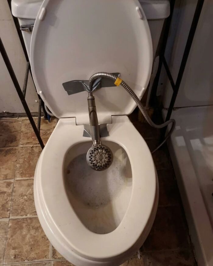 A makeshift bidet made from a showerhead taped to a toilet, an example of Slavic Science.