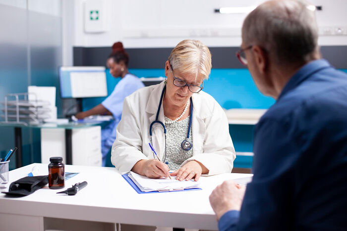 Female doctor consulting with an elderly patient in a medical office