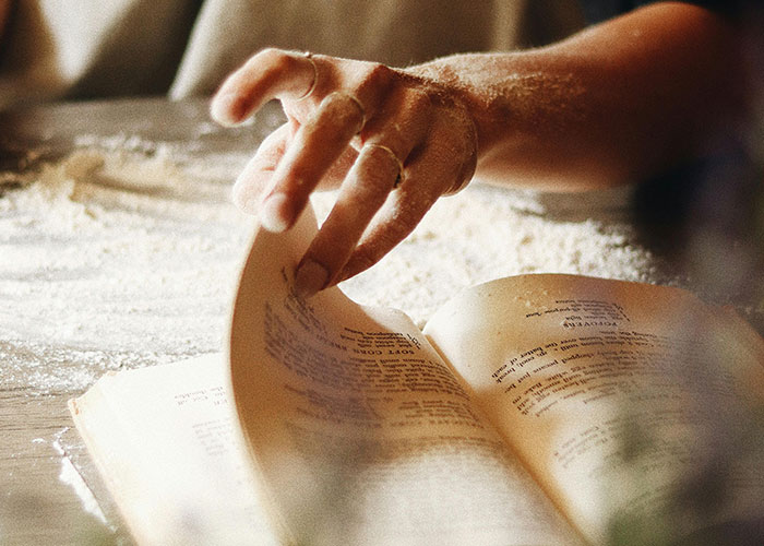 Person turning page of old book about secrets