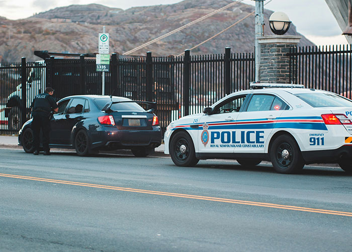 Police officer talking to driver during traffic stop for life mistakes