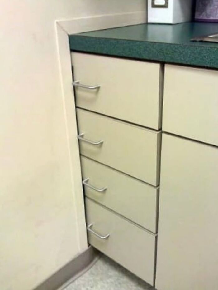 Cabinet drawer handles blocked by wall causing usability design fail
