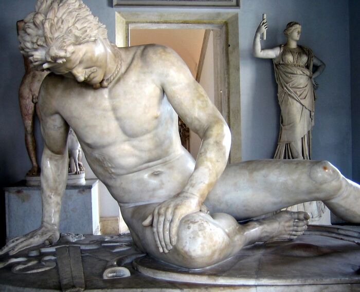 Marble sculpture of a fallen man in pain, illustrating brutal historical acts of revenge