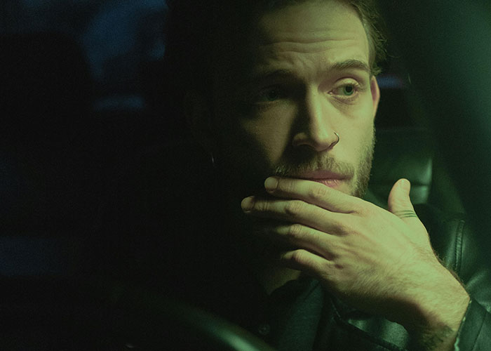 Man in dark car contemplating, illustrating wild secrets people keep