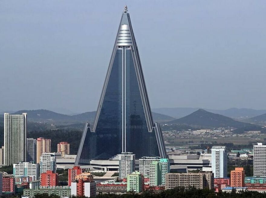 The Ryugyong Hotel surrounded by city buildings