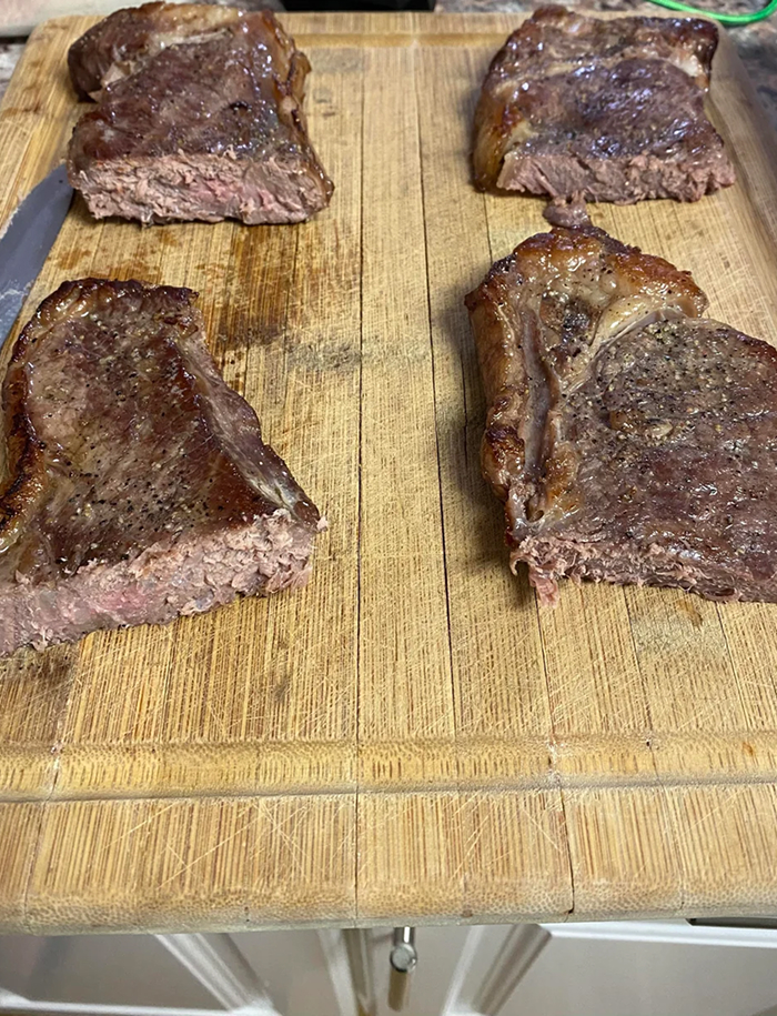 Grilled steak pieces on a wooden cutting board, relevant to cooking myths about meat preparation
