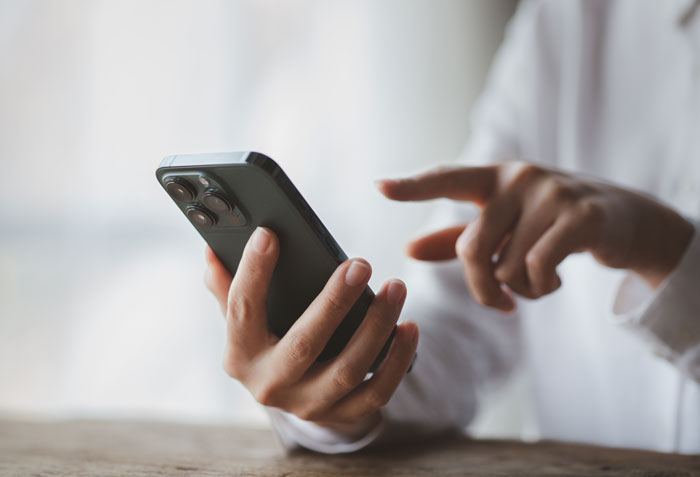Man holding smartphone showing texting as gross relationship behavior