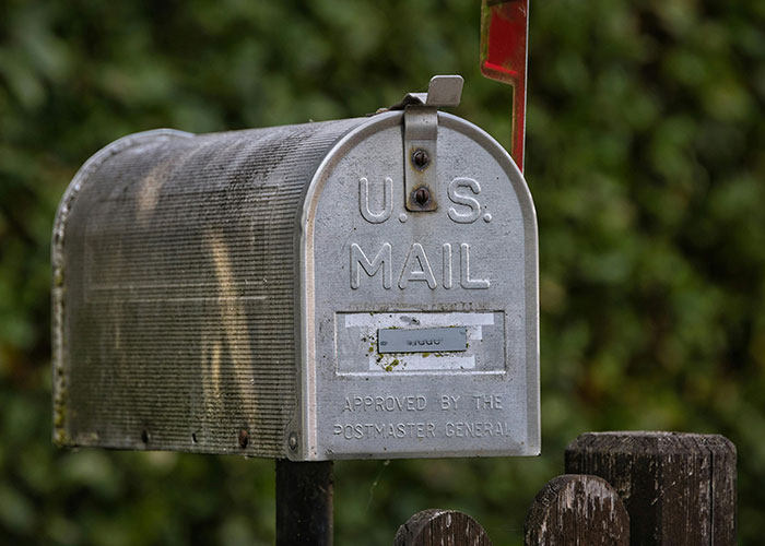 Old U.S. mail mailbox with raised red flag, depicting mail-related legal offenses