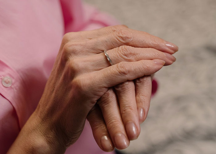 Close up of hands with wedding ring symbolizing wedding conflict