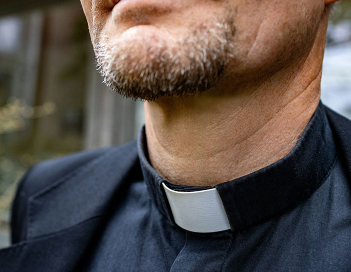 Close-up of priest wearing clerical collar during wedding
