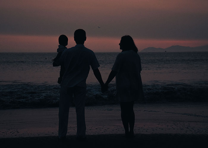 Family watching sunset, contrasting the fate of popular kids who peaked in high school