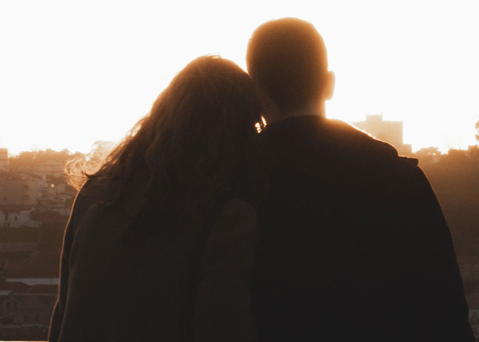 Silhouette of couple at sunset contemplating killers