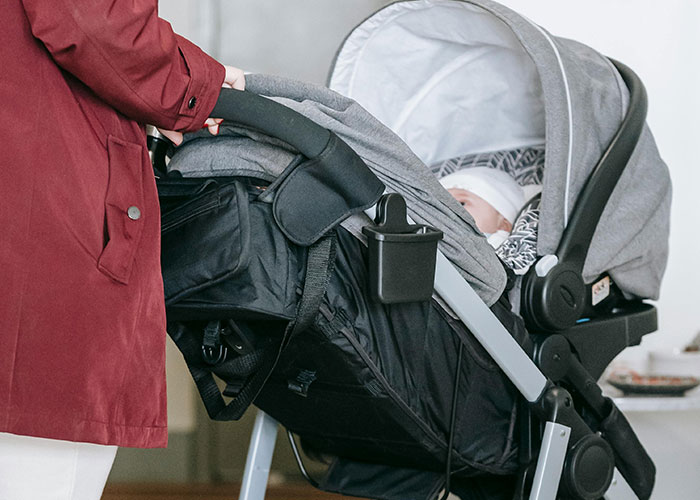 Adult pushing a baby stroller indoors, related to legal offense scenarios