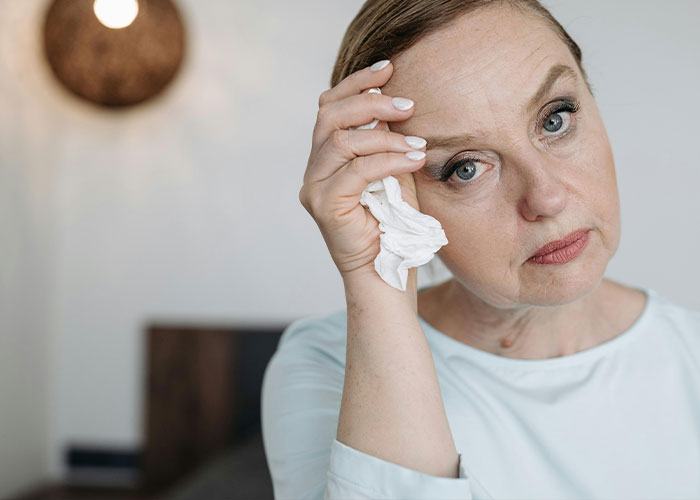 Worried woman wiping tears, emotional wedding moment