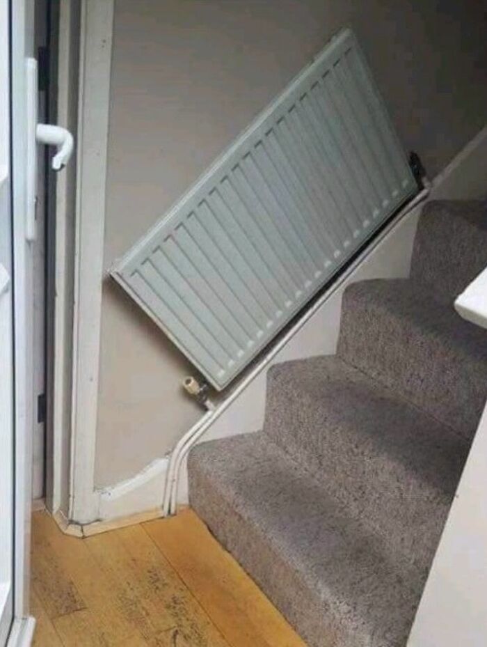 Radiator installed awkwardly on staircase wall causing design fail