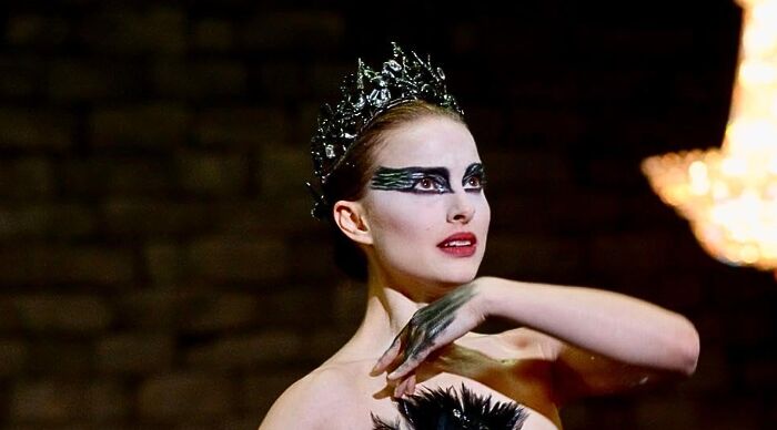 Natalie Portman as the Black Swan with a dark crown and elaborate makeup, ideal for a popular fiction and movies would you rather poll.