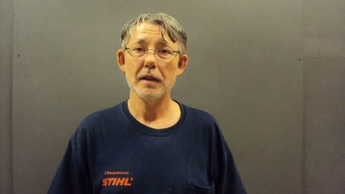 Man with gray hair and glasses in a dark blue shirt, related to an unsolved mystery that was solved.
