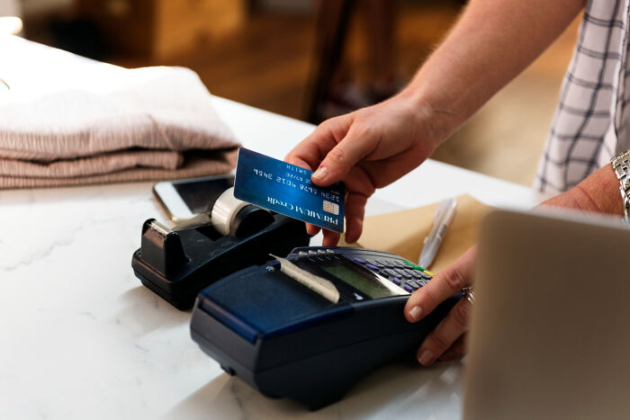 Person paying with credit card on payment terminal