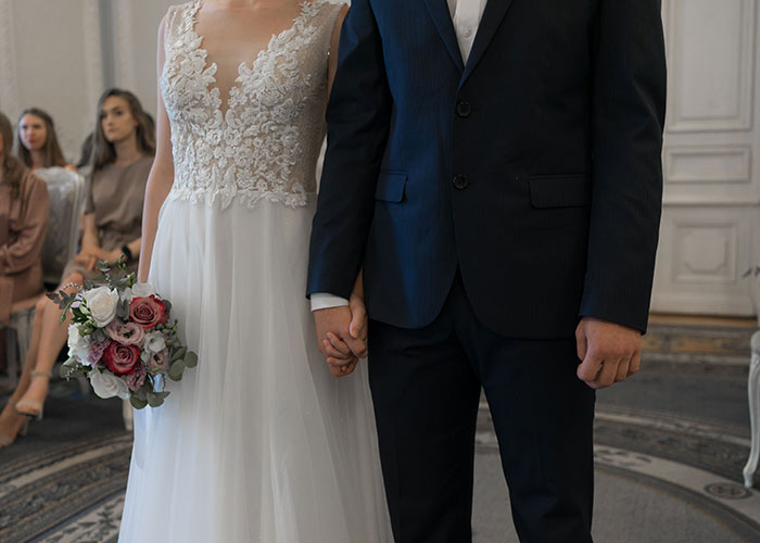 Bride and groom holding hands during wedding ceremony