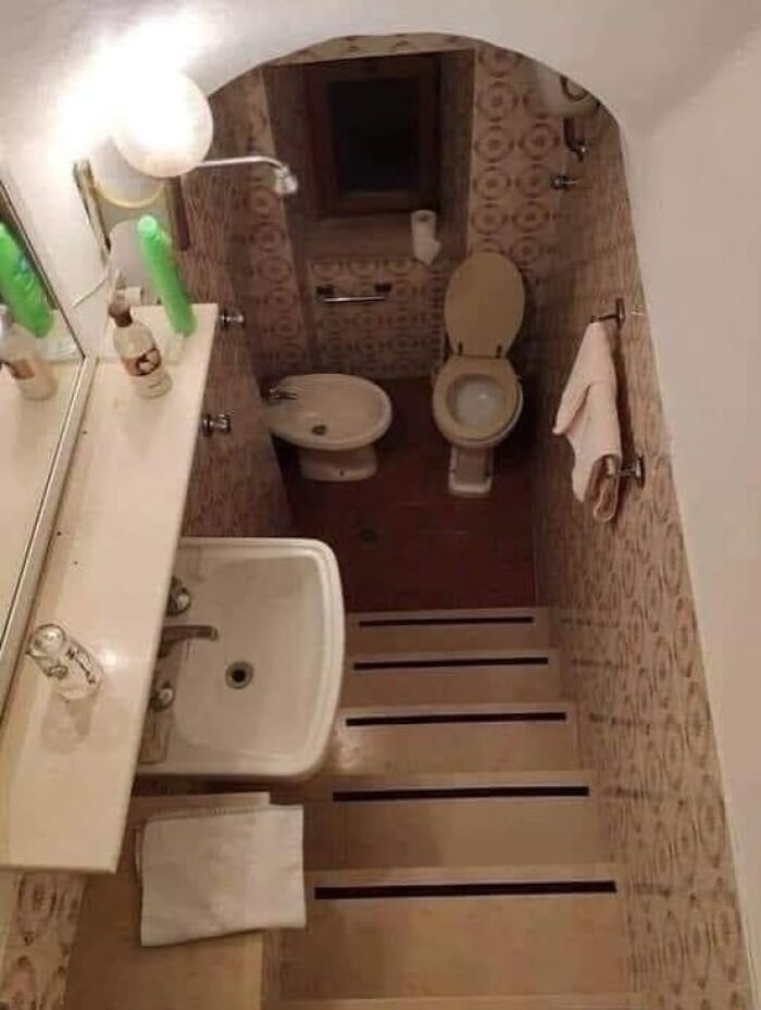 Tiny narrow bathroom with step-like floor and cramped fixtures design fail