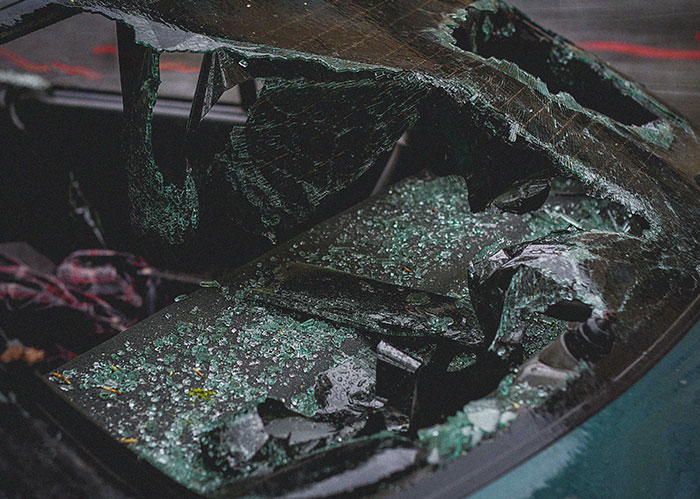 Shattered car window after an accident, connected to popular kids who peaked in high school