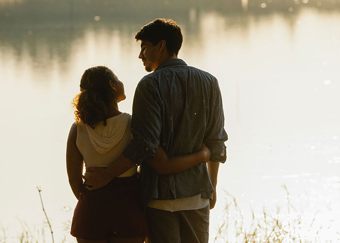 A couple embracing by a lake, illustrating Family Isn't Everything, prioritizing individual relationships.