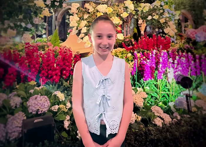 Girl standing among colorful flowers in investigation of vanished child Girl standing among colorful flowers in investigation of vanished child