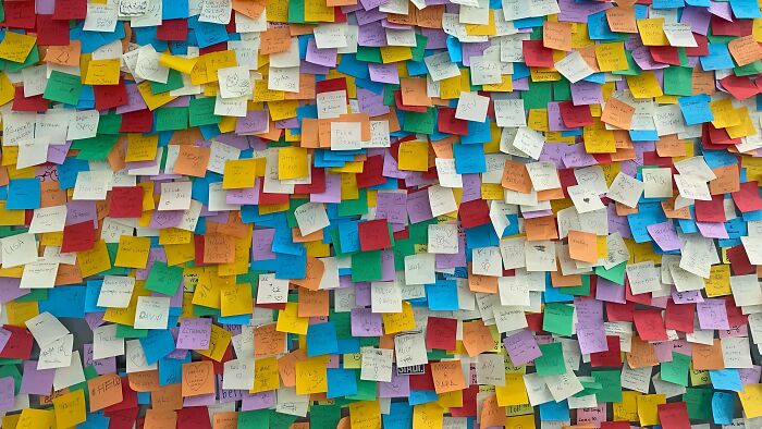 Wall covered in colorful sticky notes representing mind-bending dilemma ideas