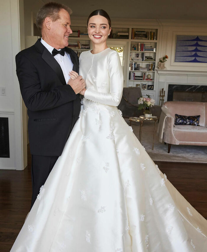 Miranda Kerr in an elegant celebrity wedding dress, with her father, celebrating her wedding day.