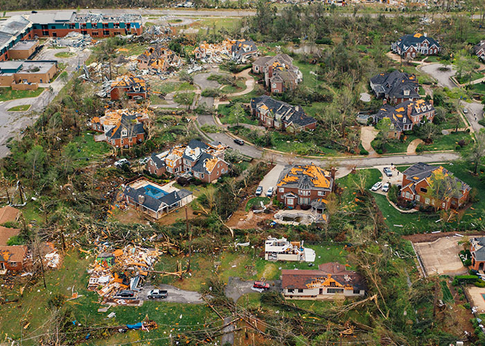 Aerial view of tornado damage urging to leave immediately