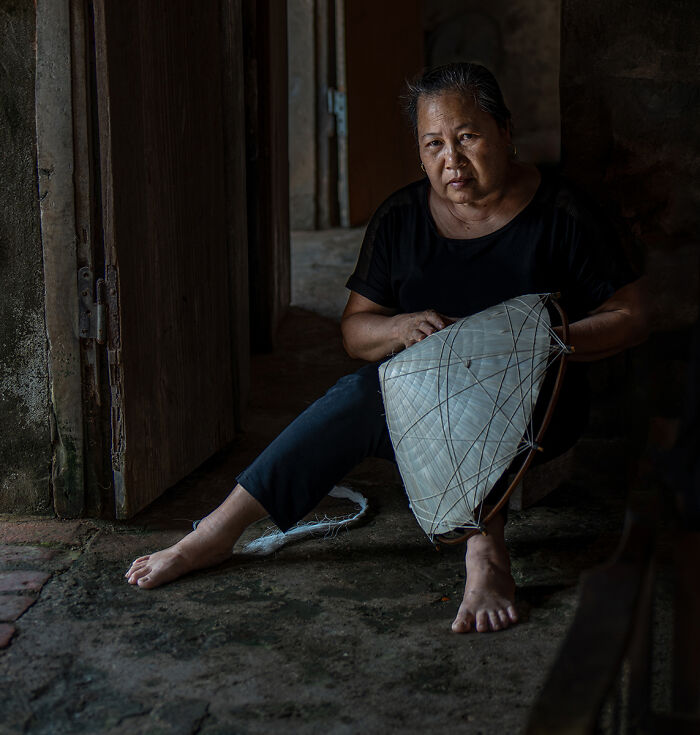 A woman crafting a traditional hat, capturing the stories of people through photography for the 2025 Chromatic Awards.
