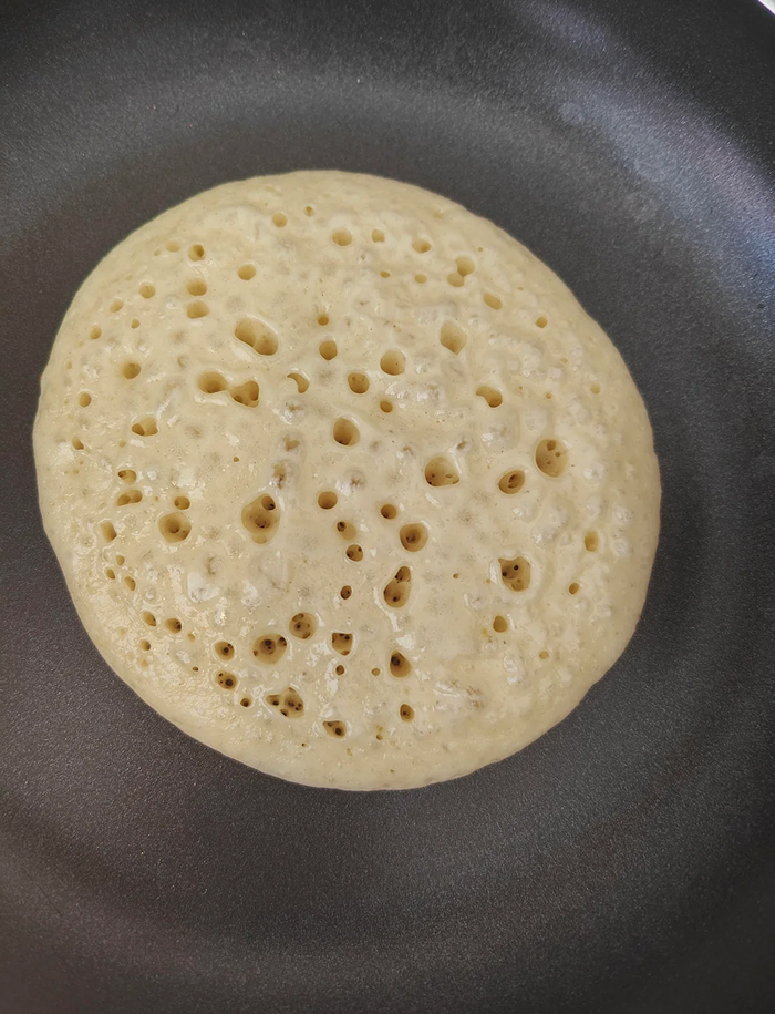 Pancake cooking with bubbles in nonstick pan for cooking myths