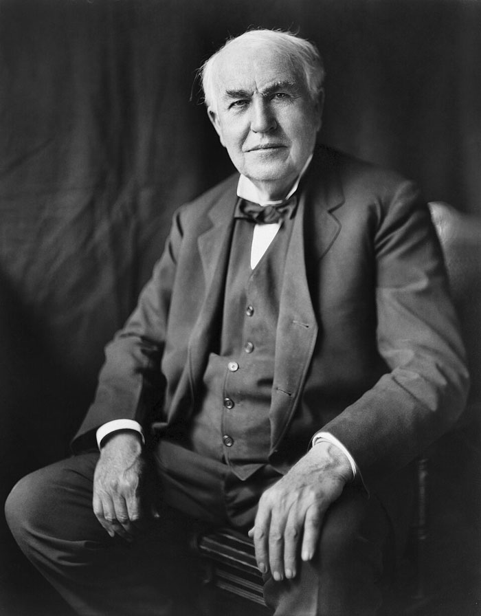 Black and white photo of romanticized historical figure in formal suit