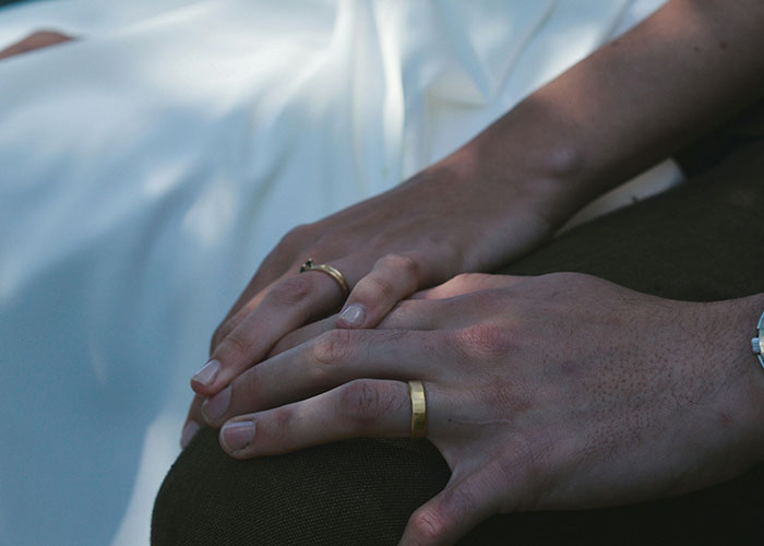Hands of couple wearing wedding rings symbolizing relationship mistakes