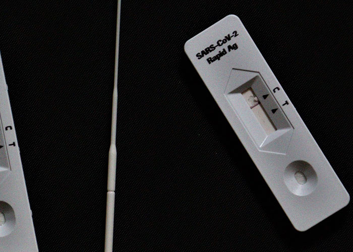 COVID-19 rapid antigen test, symbolizing challenges that may affect kids' contact with parents.