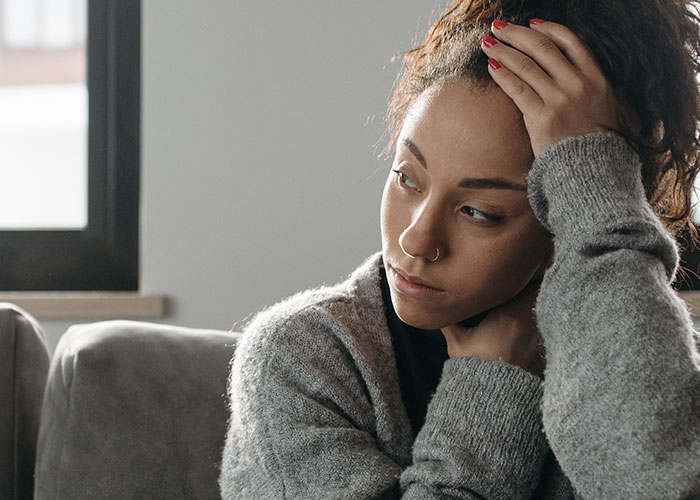 A sad woman experiencing the aftermath of horrible things committed by close friends that broke her trust.