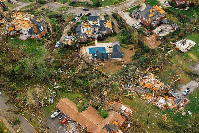 Aerial view of tornado devastation with damaged homes and debris