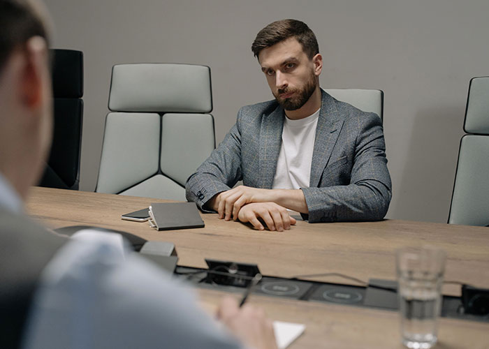 Man in serious meeting reflecting on life decisions
