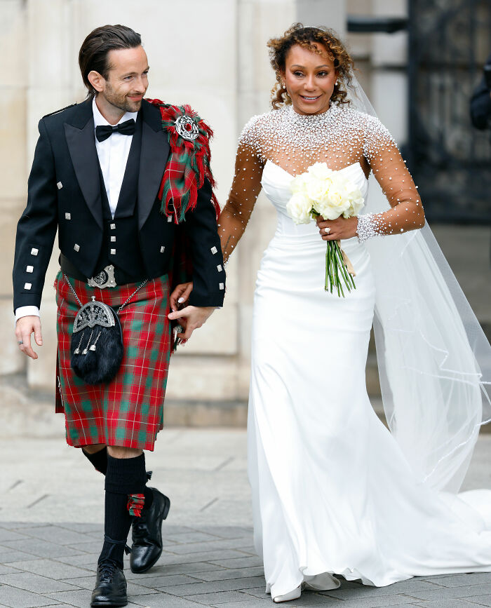 Mel B and her husband leaving a ceremony, showcasing their celebrity wedding dresses.