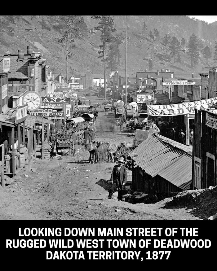 A wide shot of Deadwood, Dakota Territory in 1877, a rugged Wild West town, an interesting historical photo.