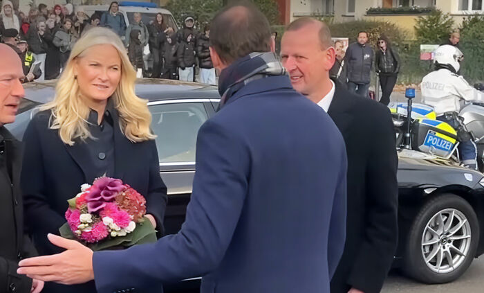 Norwegian Crown Princess's son with officials and bouquet outside courthouse Norwegian Crown Princess's son with officials and bouquet outside courthouse