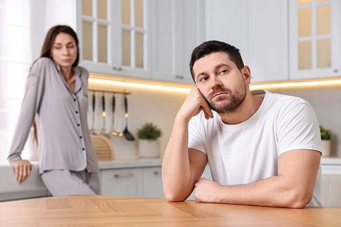 Couple in kitchen looking upset over MIL haunting